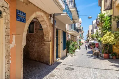 an alley in an old town with people walking down the street at Amy's Little Gem in Chania Town