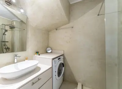 a bathroom with a washing machine and a sink at Amy's Little Gem in Chania Town