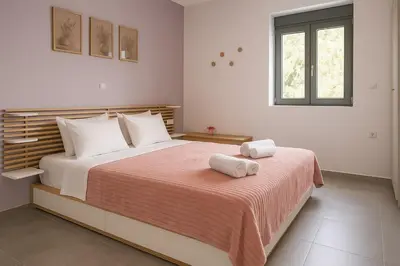 a bedroom with a large bed with two towels on it at Yalos Standard Studio - 5 mins to Elafonisi beach in Agios Padeleimon