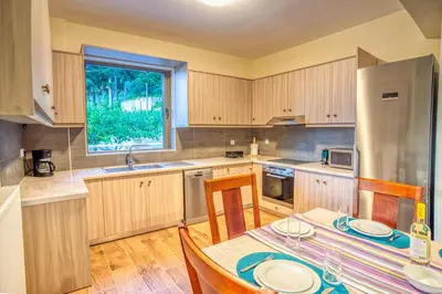 a kitchen with a table and chairs and a refrigerator at Earthly Paradise in Kissamos
