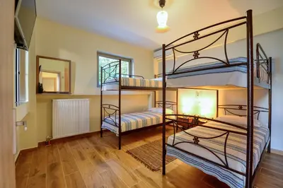 a room with three bunk beds and a lamp at Earthly Paradise in Kissamos