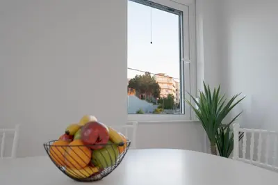 a bowl of fruit sitting on a counter next to a window at Nafsika's Cozy Apartment in Chania Town