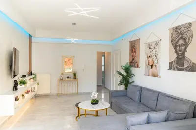 a living room with a couch and a table at Nafsika's Cozy Apartment in Chania Town