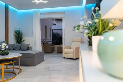 a living room with a couch and a table at Nafsika's Cozy Apartment in Chania Town