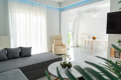 a living room with a couch and a table at Nafsika's Cozy Apartment in Chania Town