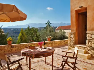 a table and chairs on a patio with a view at Natalia's Houses in Chania Town