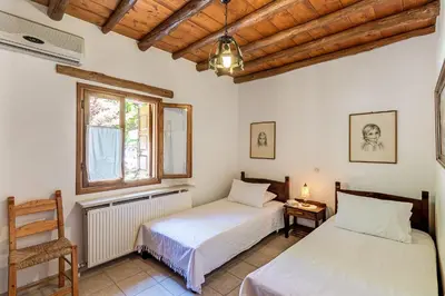 a bedroom with two beds and a window at Natalia's Houses in Chania Town