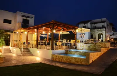 an outdoor patio with a gazebo at night at Ledra Maleme Hotel in Maleme