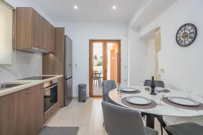 a kitchen with a table and chairs in a kitchen at Villa Andromeda Fres in Frés