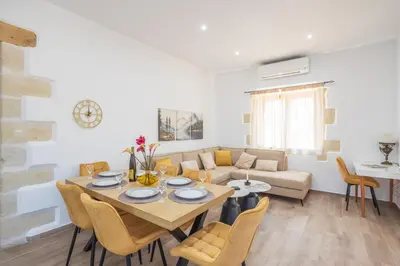a living room with a table and a couch at Villa Andromeda Fres in Frés