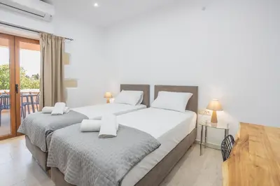 a bedroom with two beds and a balcony at Villa Andromeda Fres in Frés