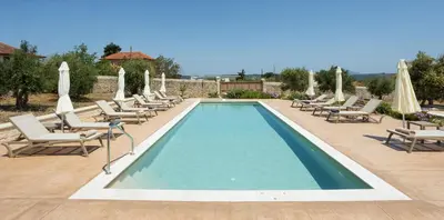 a swimming pool with lounge chairs and umbrellas at Villa Andromeda Fres in Frés