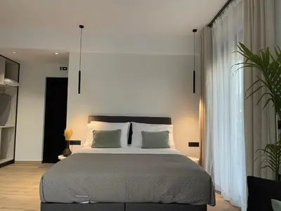 a bedroom with a large bed with two pillows at Casa Nero in Chania Town