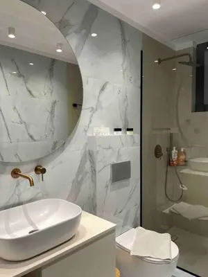 a white bathroom with a sink and a shower at Casa Nero in Chania Town