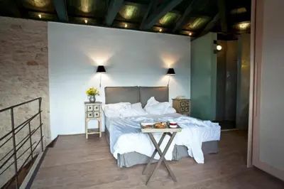 a bedroom with a bed and a table at Villa Athermigo in Gavalochori
