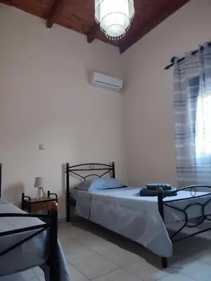 a bedroom with two beds and a chandelier at Viewphoria in Maláxa