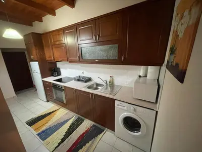 a kitchen with a sink and a washing machine at Viewphoria in Maláxa