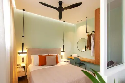 a bedroom with a bed with a ceiling fan at Eftihia Studios Paleochora in Palaiochóra