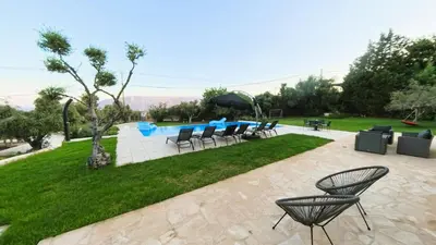 a group of chairs and tables in a yard at MG Residence Boutique Holiday Home in Korakiaí