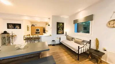a living room with a couch and a table at MG Residence Boutique Holiday Home in Korakiaí