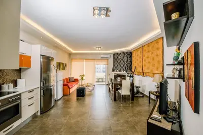 a kitchen and living room with a dining room at Mary's modern apartment in Kissamos