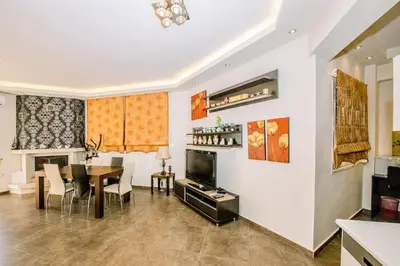 a living room with a table and a dining room at Mary's modern apartment in Kissamos