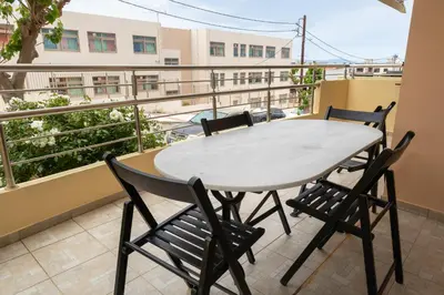 a table and chairs on a balcony with a view at Maisonette in Koumpeli in Koumpeli