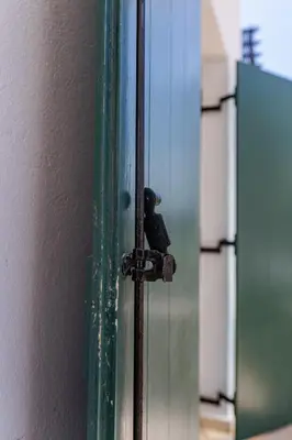 a glass door with a bird sitting on top of it at Central Kalyves Appartment - 5 min waking to the beach in Kalyves
