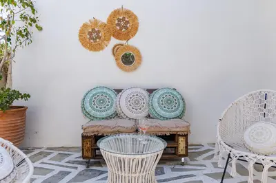 a living room with a couch and chairs at Central Kalyves Appartment - 5 min waking to the beach in Kalyves