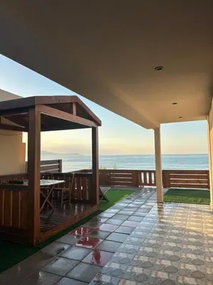 a view of the ocean from the porch of a house at Villa Tile in Agia Marina Nea Kydonias