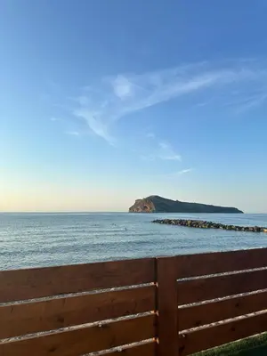 a view of the ocean with a wooden fence at Villa Tile in Agia Marina Nea Kydonias