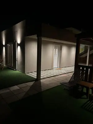a house lit up at night with a porch at Villa Tile in Agia Marina Nea Kydonias