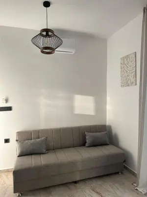 a living room with a couch and a chandelier at Villa Tile in Agia Marina Nea Kydonias