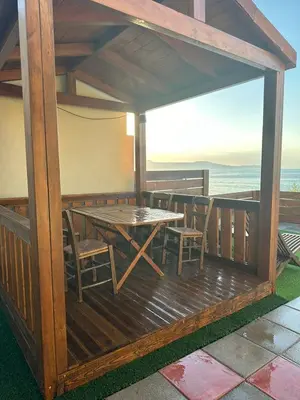 a wooden deck with a table and chairs at Villa Tile in Agia Marina Nea Kydonias