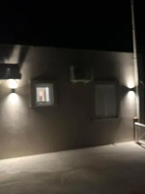 a dark room with two lights on the wall at Villa Tile in Agia Marina Nea Kydonias