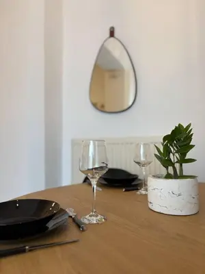a table with two wine glasses and a plant on it at Semeli House in Chania Town