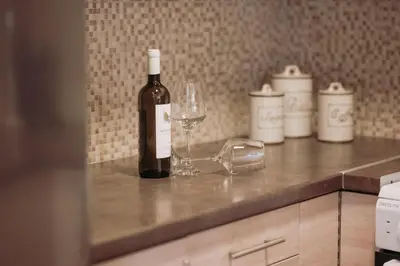 a bottle of wine and a glass on a counter at Semeli House in Chania Town