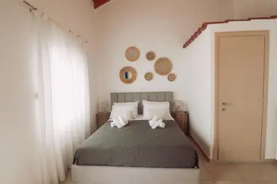 a bedroom with a bed with two white pillows at Semeli House in Chania Town