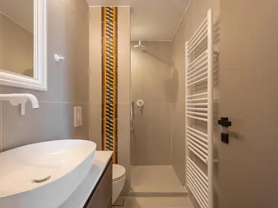 a bathroom with a sink and a toilet and a shower at Villa Portokalea in Maleme