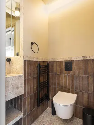 a bathroom with a toilet and a sink and a mirror at Villa Portokalea in Maleme
