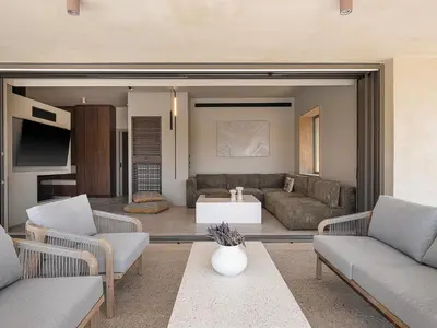 a living room with a couch and a table at Villa Portokalea in Maleme