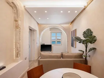 a living room with a table and chairs at Venetian Harbour Residence in Chania Town