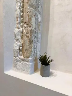 a potted plant sitting on a shelf next to a wall at Venetian Harbour Residence in Chania Town