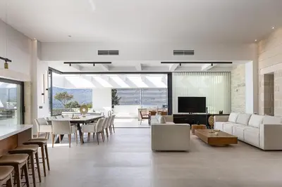 a living room with a couch and a table at Versante Rousso - Modern Living in Nature's Embrace by etouri in Káïna