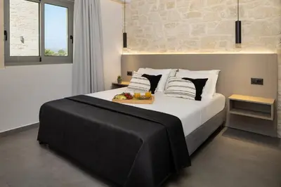 a bedroom with a bed with a tray of fruit on it at Luxurious Villas Rocca Blanco 1 & 2 in Kounoupidhianá
