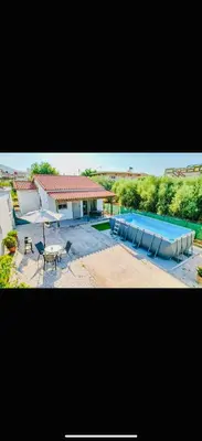 a picture of a swimming pool and a house at Cretan Blue Bungalow Chania in Chania Town