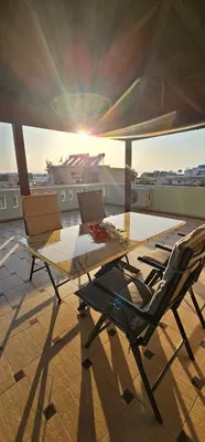 a table and chairs on top of a roof at Sea View appartment in Chania Town