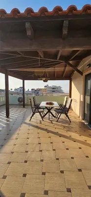 a patio with two chairs and a table on a roof at Sea View appartment in Chania Town