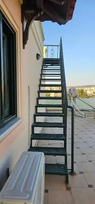 a set of stairs with a bench next to a building at Sea View appartment in Chania Town