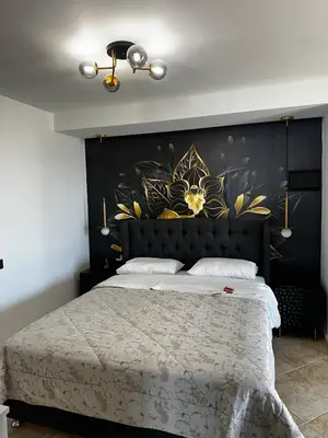 a bedroom with a large bed with a floral headboard at Sea View appartment in Chania Town